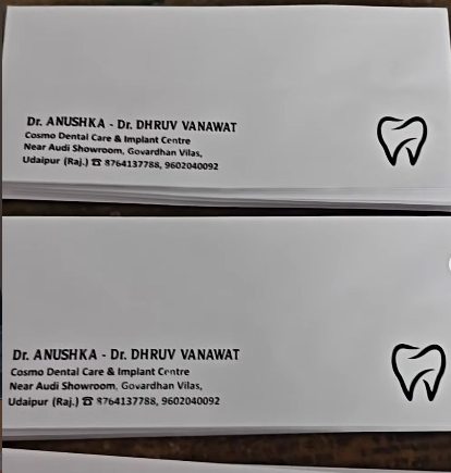 A clean white dental clinic business card design displayed in stacked mockups, featuring bold black typography with doctor names, clinic address, phone numbers, and a minimal tooth logo on the right side.